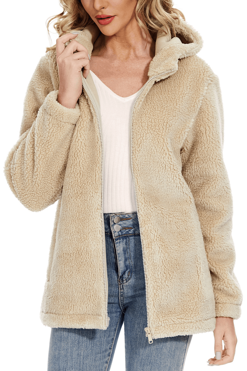 Woman wearing a stylish fluffy beige jacket with hood and zipper, perfect for staying cozy and fashionable in cold weather.